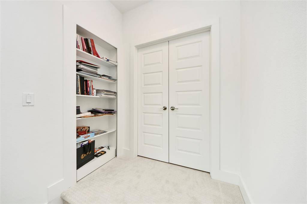 Charming built-in bookshelf offers great storage and display options in the upstairs hallway—ideal for books, files, or personal touches.