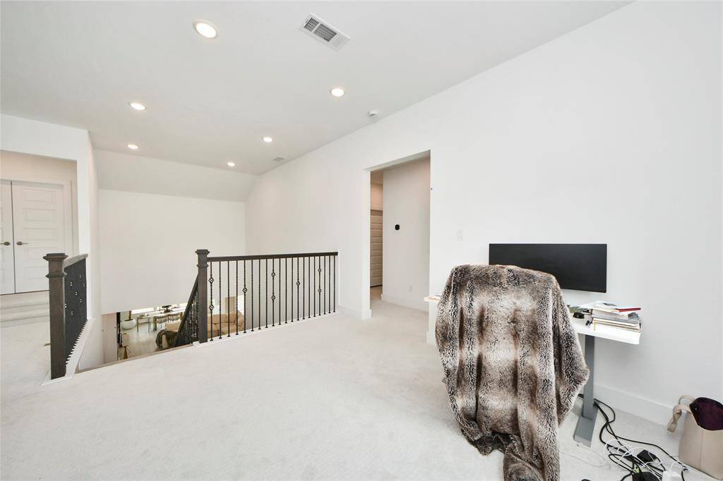 Another view of the upstairs office nook showing open sight lines and access to additional rooms.