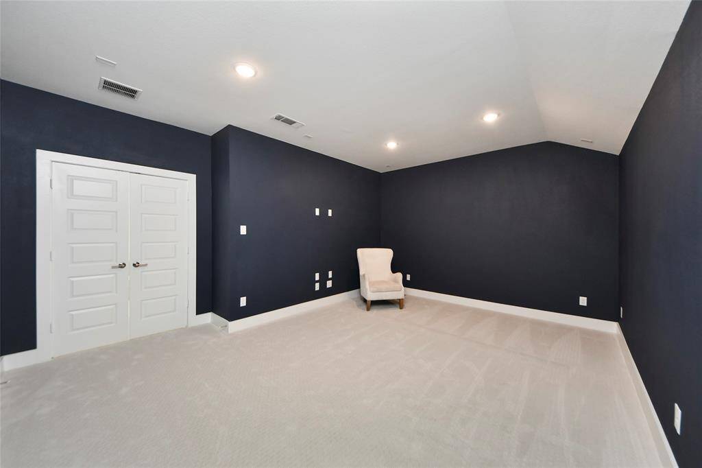 Dedicated media room with dark walls and no windows for the ultimate home theater experience.