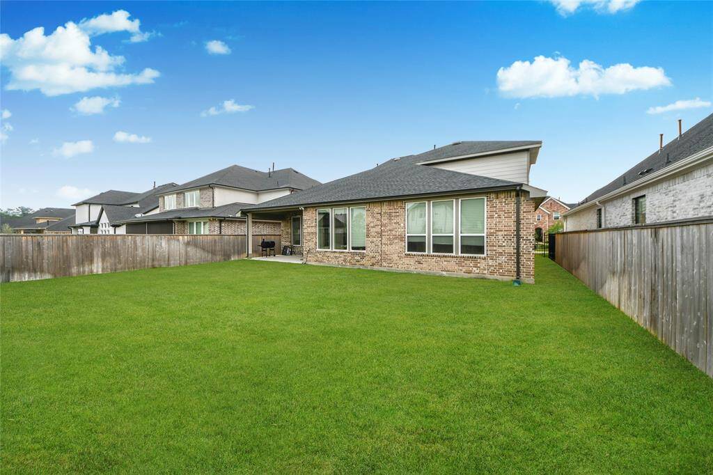 Fully fenced and oversized backyard with endless potential—perfect for a future pool, playground, or garden retreat.