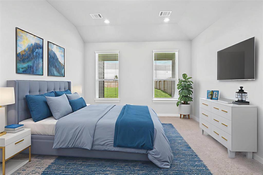 Come and unwind after a long day in this magnificent primary suite! This spacious room features plush carpet, warm paint, high ceilings, and large windows with privacy blinds!