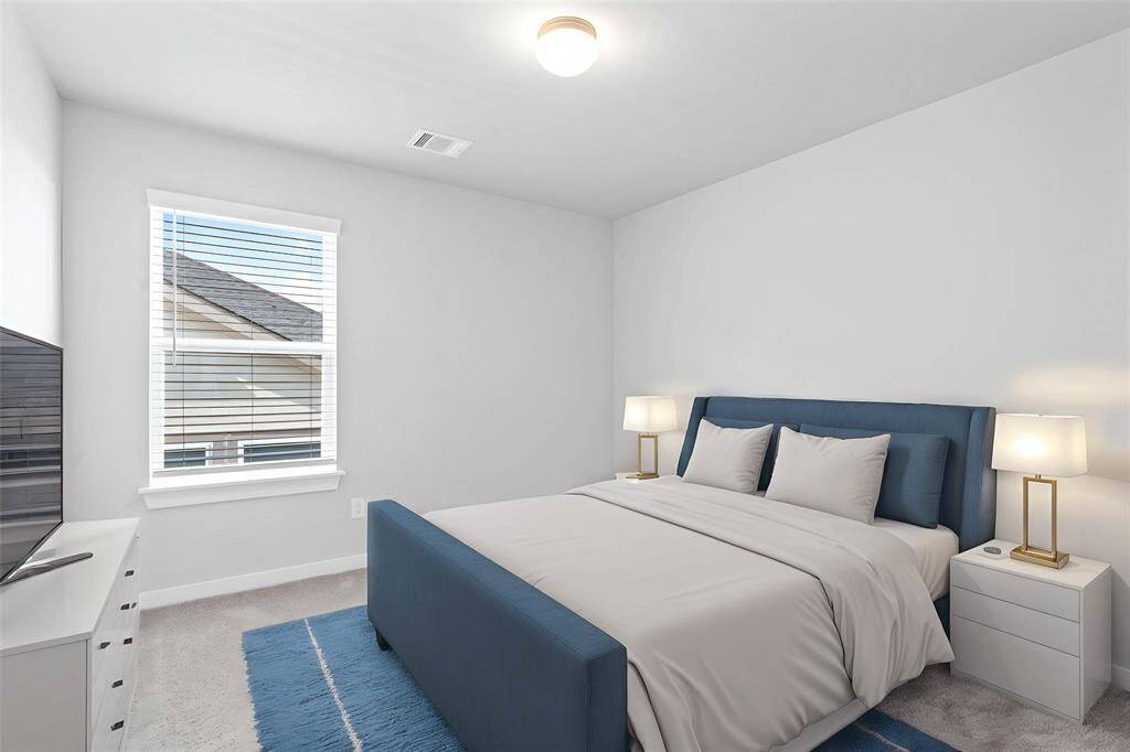 Secondary bedroom features plush carpet, custom paint, high ceilings, closet space, and a large window with privacy blinds.