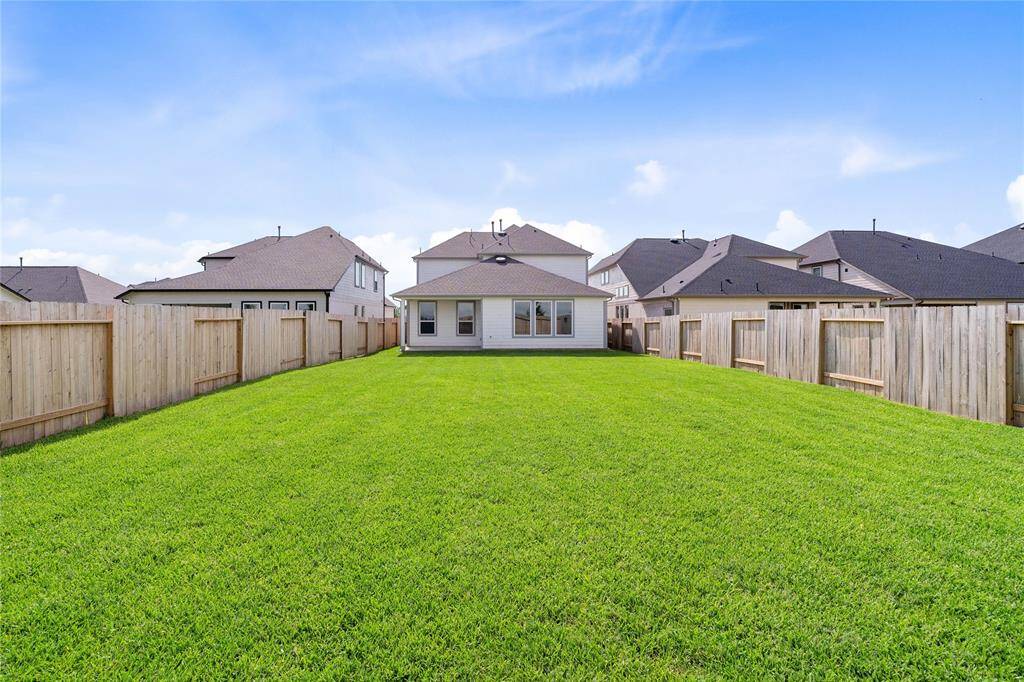 Additional view of this OVERSIZED back yard!