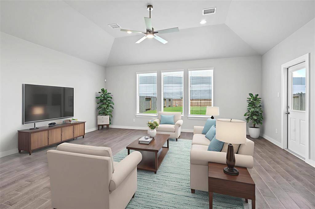 Gather the family and guests together in your lovely family room! Featuring high ceilings with recessed lighting and ceiling fan, custom paint, gorgeous wood look tile floors, and large windows that provide plenty of natural lighting throughout the day.