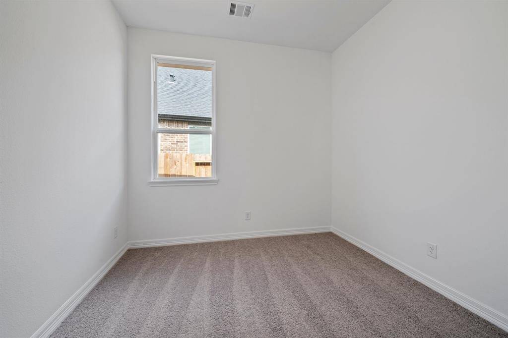 Your secondary bedroom features plush carpet, fresh paint, closet, and a large window that lets in plenty of natural lighting.