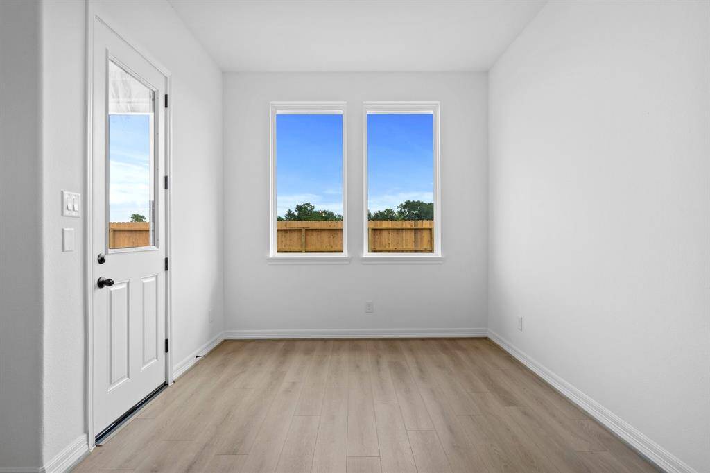 With an abundance of natural light streaming through the windows, the breakfast nook is bathed in a sunny glow, creating the perfect atmosphere to enjoy your morning coffee or a family breakfast.