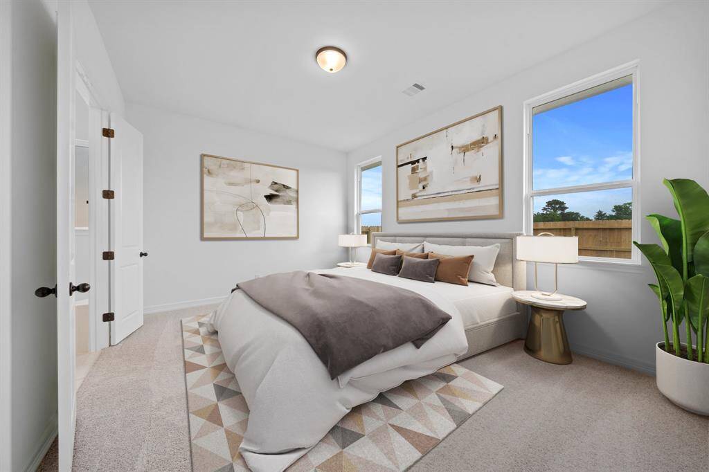 The primary bedroom is generously sized, creating a tranquil and spacious retreat that offers ample room for relaxation. Featuring plush carpet, high ceilings, fresh paint, and large windows that lets in natural lighting throughout the day.