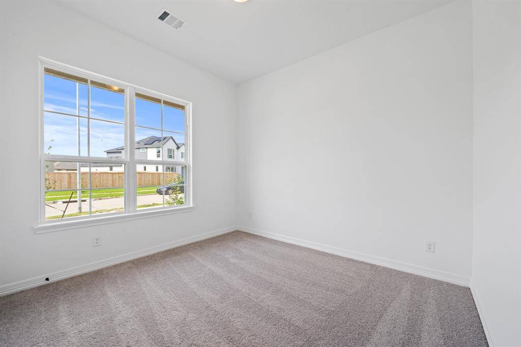 Your secondary bedroom features plush carpet, fresh paint, closet, and a large window that lets in plenty of natural lighting.