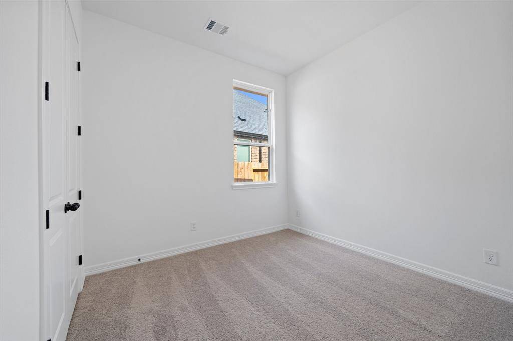 Your secondary bedroom features plush carpet, fresh paint, closet, and a large window that lets in plenty of natural lighting.