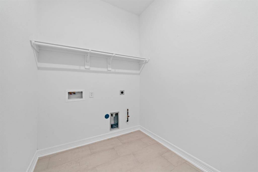 The laundry room layout is carefully planned for optimal workflow with designated areas for washing, drying, and storing.