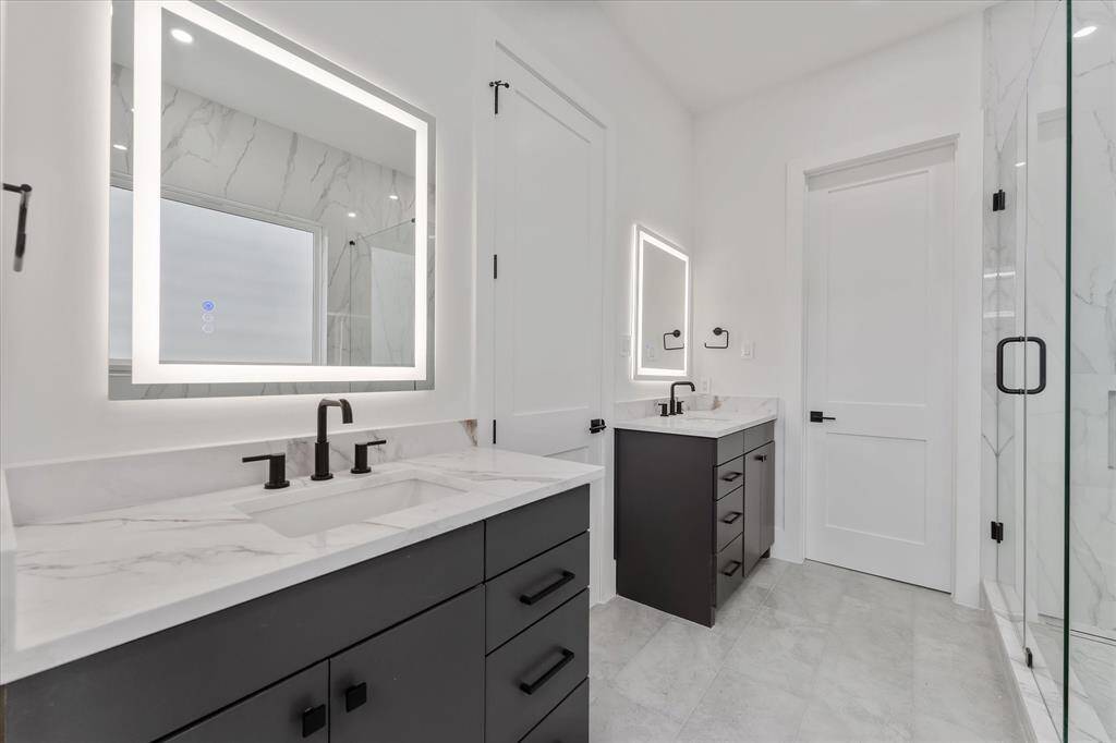 Primary Bathroom: Double custom built vanities wit LED lit mirrors!