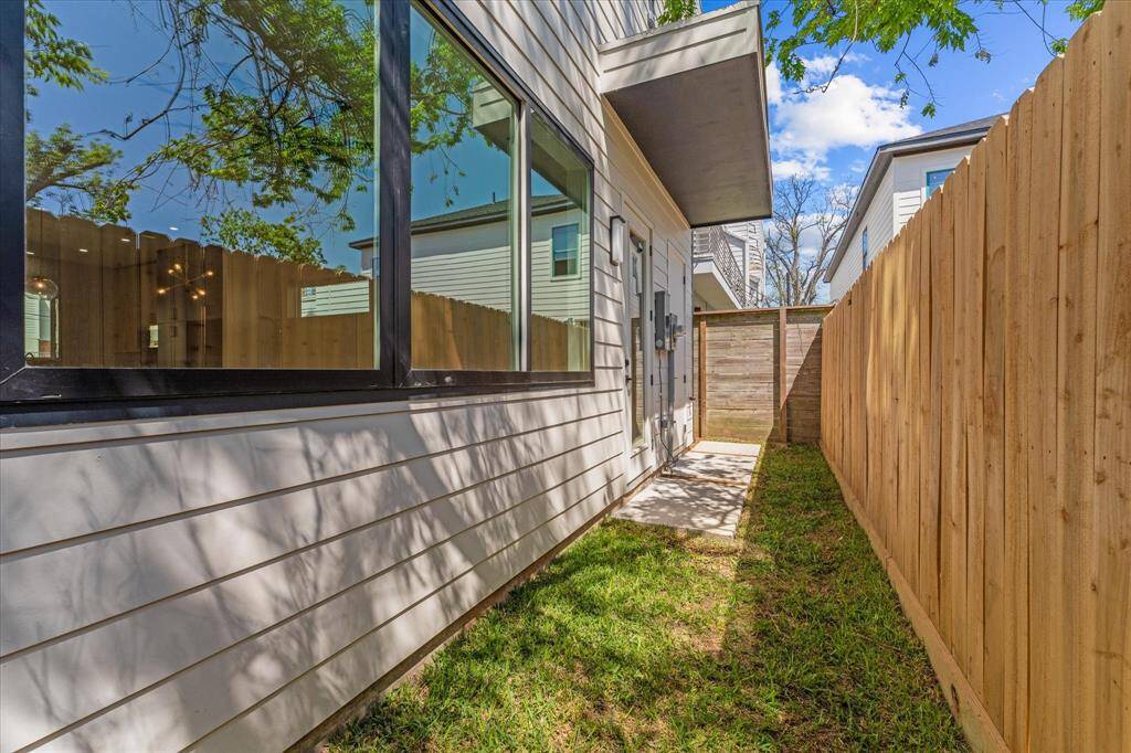 Exterior Rear: with elevated A/C unit, access to climate controlled storage room and green space.