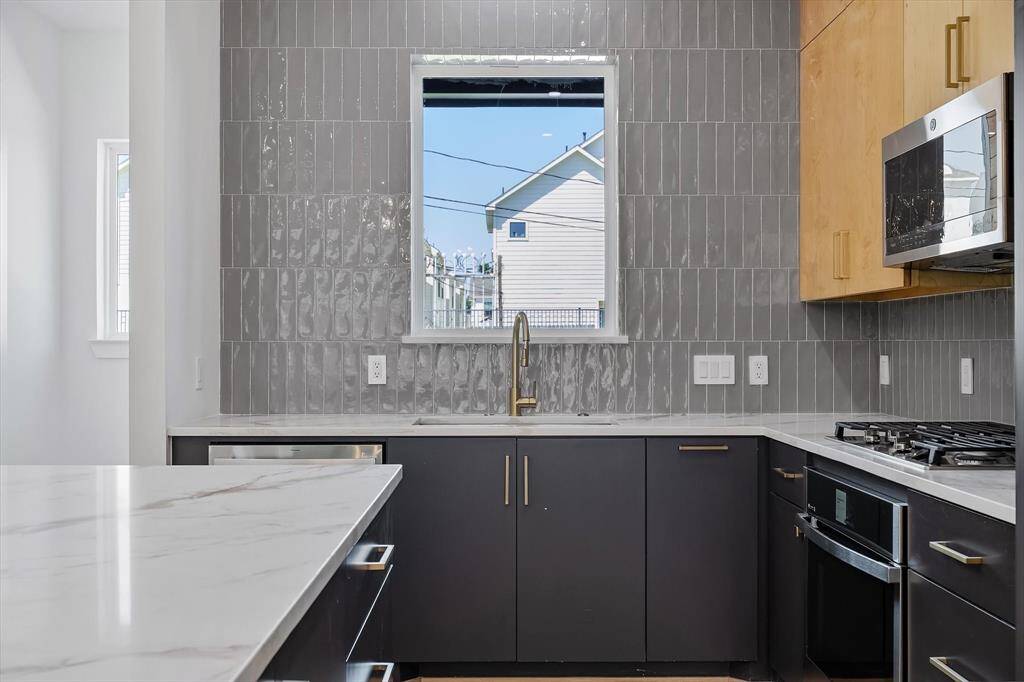 Kitchen: Tile and custom cabinetry to the ceiling.