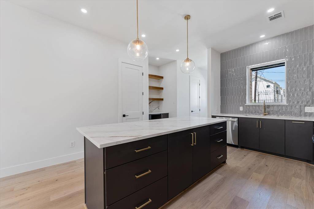 Kitchen: view of the dry bar, and island with abundant storage and counter space.