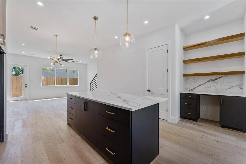 Kitchen: Custom Island and dry bar with open shelving.