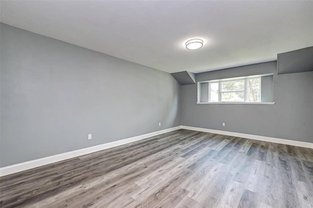 The primary bedroom has plenty of space and custom paint.