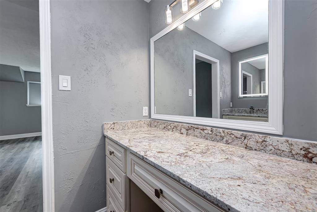 The primary bathroom features dual sinks and a vanity area.