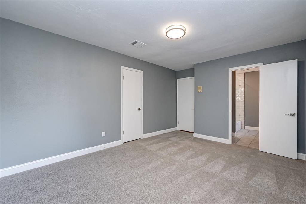 Third bedroom features awindow and plush carpet.
