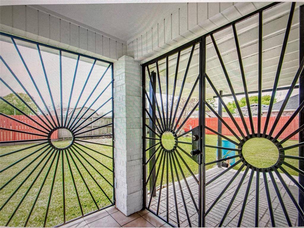 CUSTOM IRON GATE LEADING TO BACKYARD
