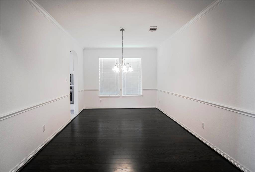 Formal dining room with hard wood floor.