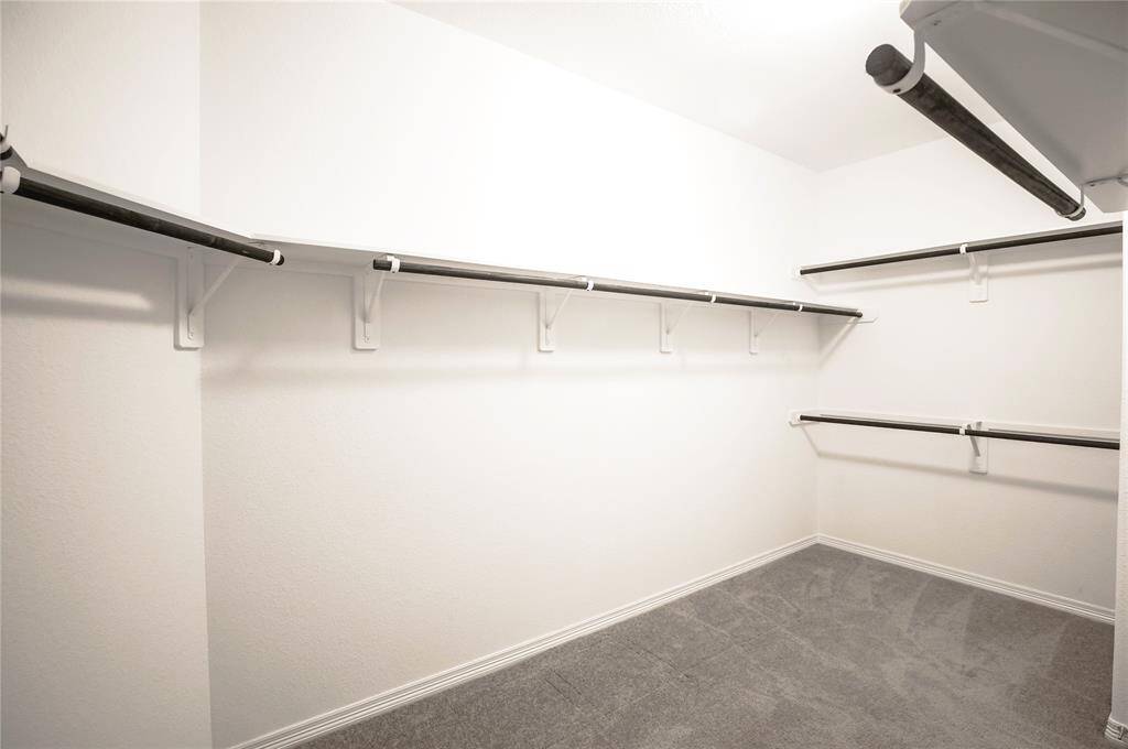 Primary bathroom with a large walk-in closet.