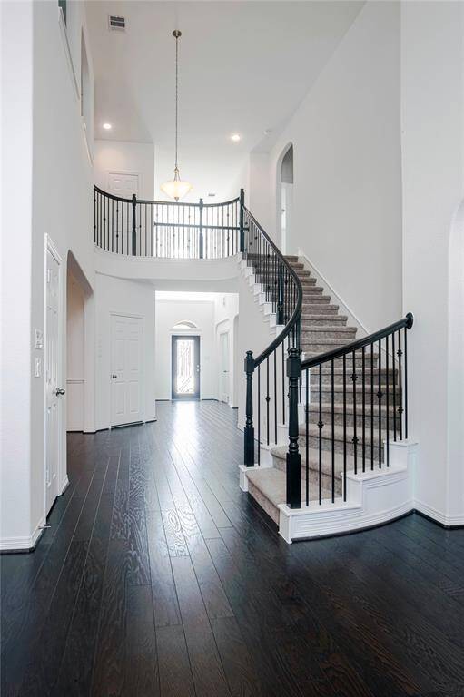 Beautiful hard wood floor with iron staircase.