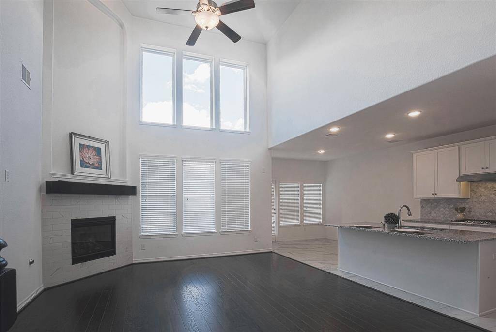 Den is next to kitchen. Open floor plan is good for entertainment.