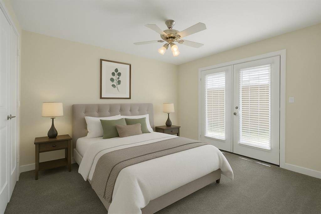 Virtually Staged Bedroom on the first floor that leads out to the back patio.  This can be used as a bedroom or an office.