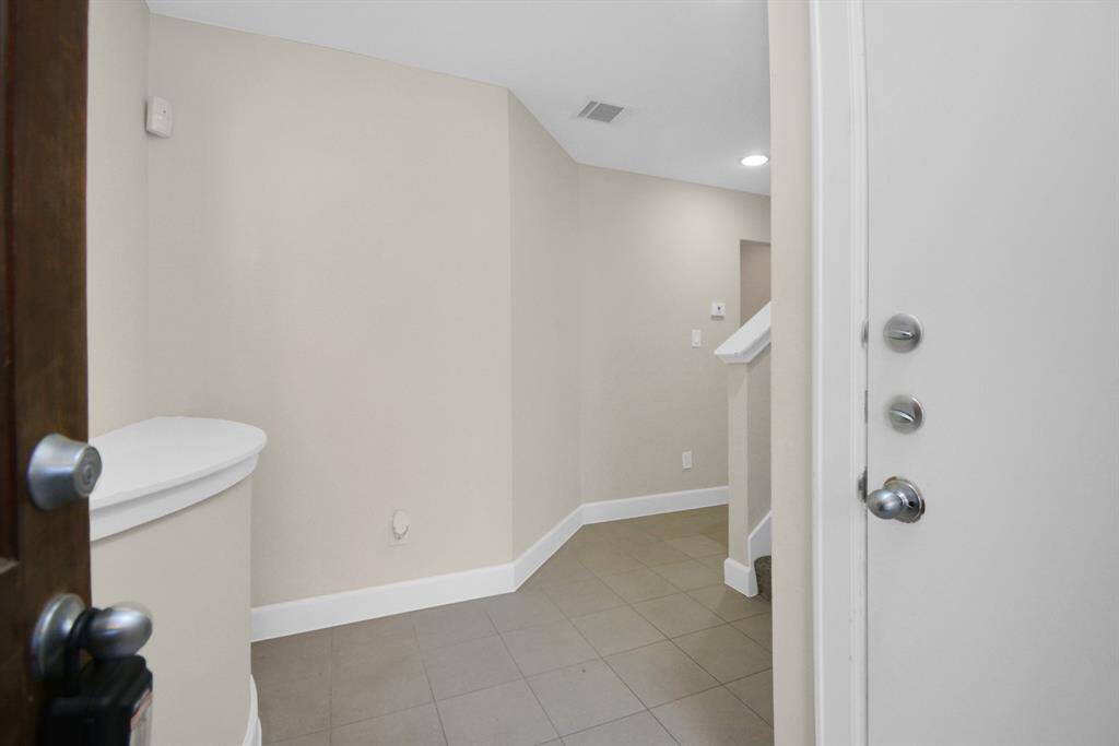 Large entryway that connects to the attached garage and downstairs living space.