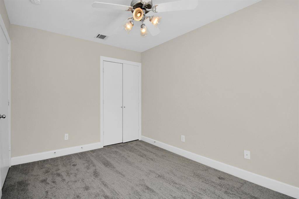 The downstairs bedroom that leads out on to the patio has a ceiling fan and large closet.