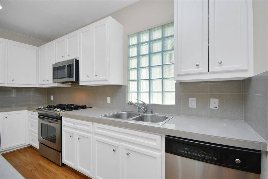 Stainless steel appliances and light and bright cabinets