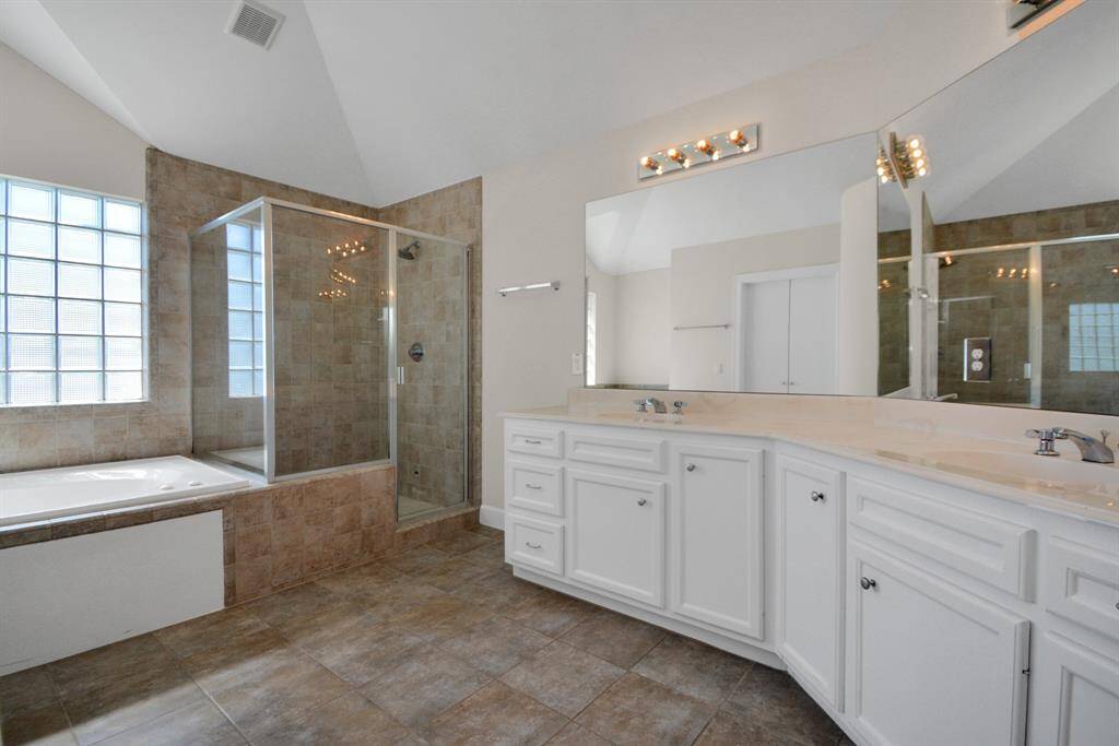 Separate tub and shower and double sinks in the primary bathroom.