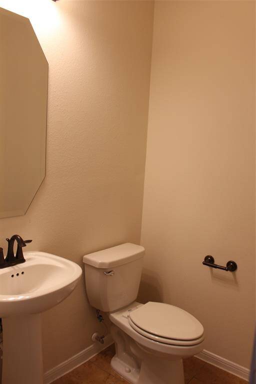 Conveniently located downstairs, this elegant powder room offers style and functionality.