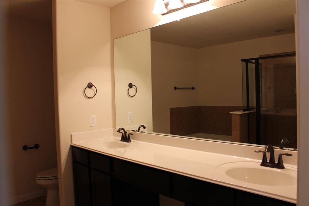 Elevate your daily routine with dual sinks in the luxurious primary bath.