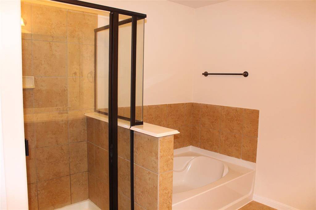 Enjoy a luxurious bathroom experience with a separate tub and shower.