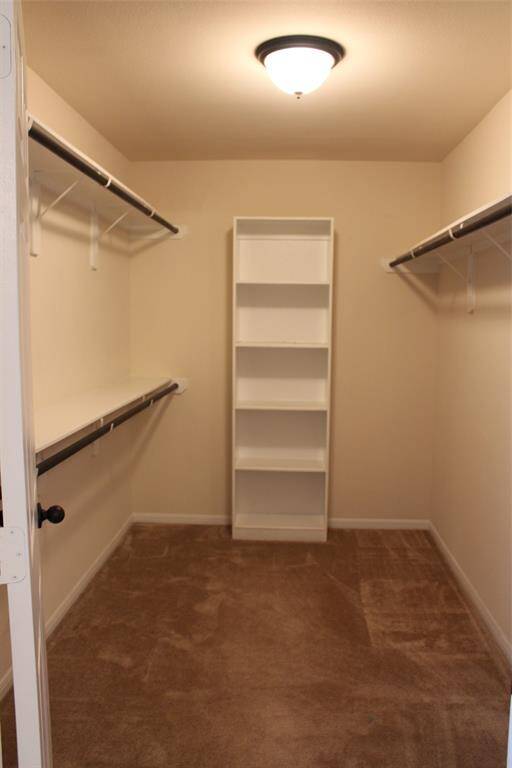 Expansive primary bedroom closet with ample shelving and hanging space for all your wardrobe needs.