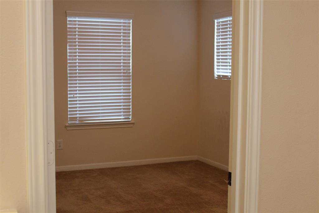 Upstairs secondary bedroom featuring a spacious walk-in closet.