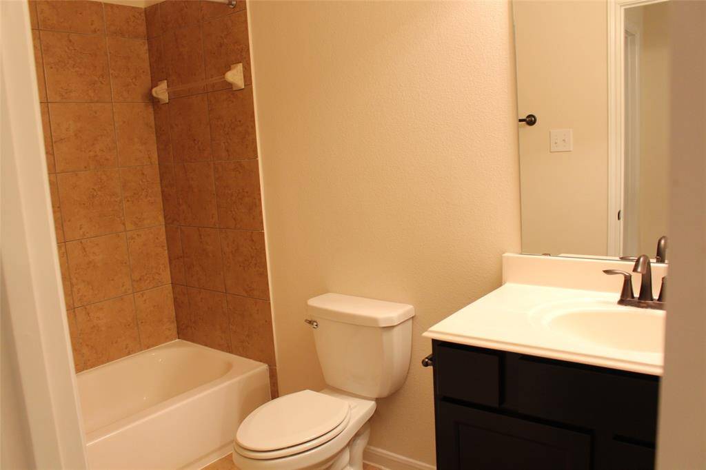 Spacious full bathroom with modern fixtures and a sleek bathtub.