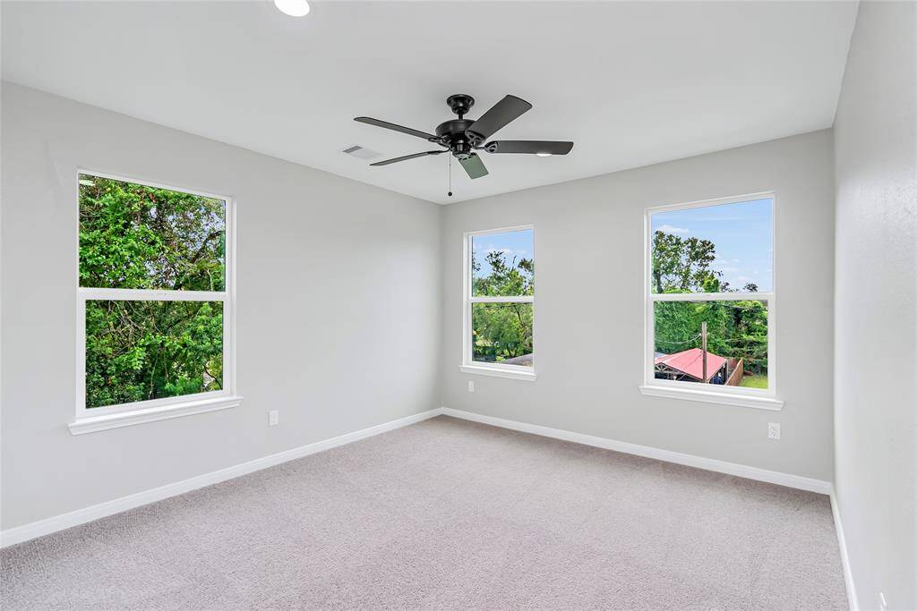 There are 2 additional rooms on the second floor. Each one has many windows and a great ceiling fan!