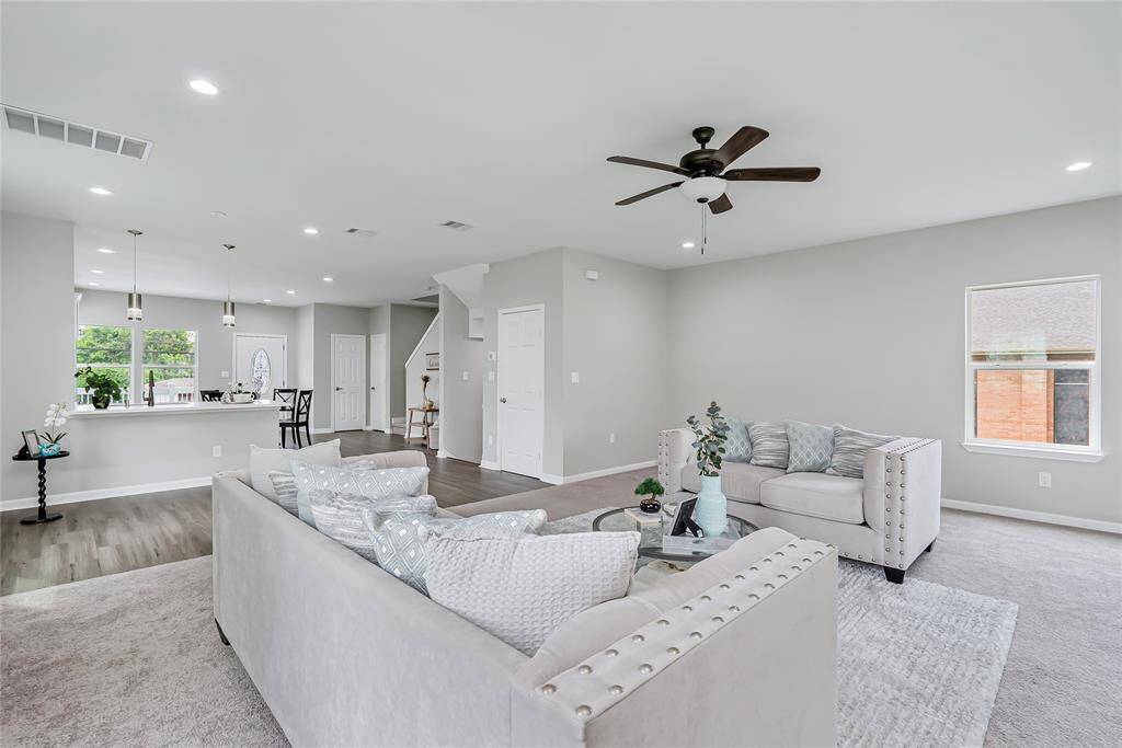 The living room opens to the kitchen and dining areas, providing multiple sight lines to all areas of the home!
