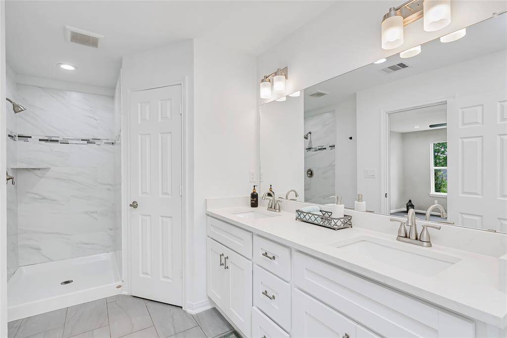 The builder had an eye for luxurious design detail! Enjoy dual sink vanity with quartz counters, crisp, white cabinetry, a standing shower and an oversized soaking tub!