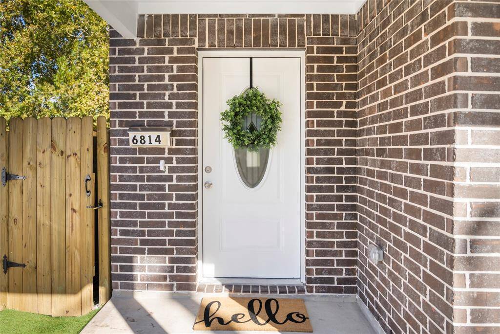 Invite guests to your home through a covered porch and beautiful doorway.