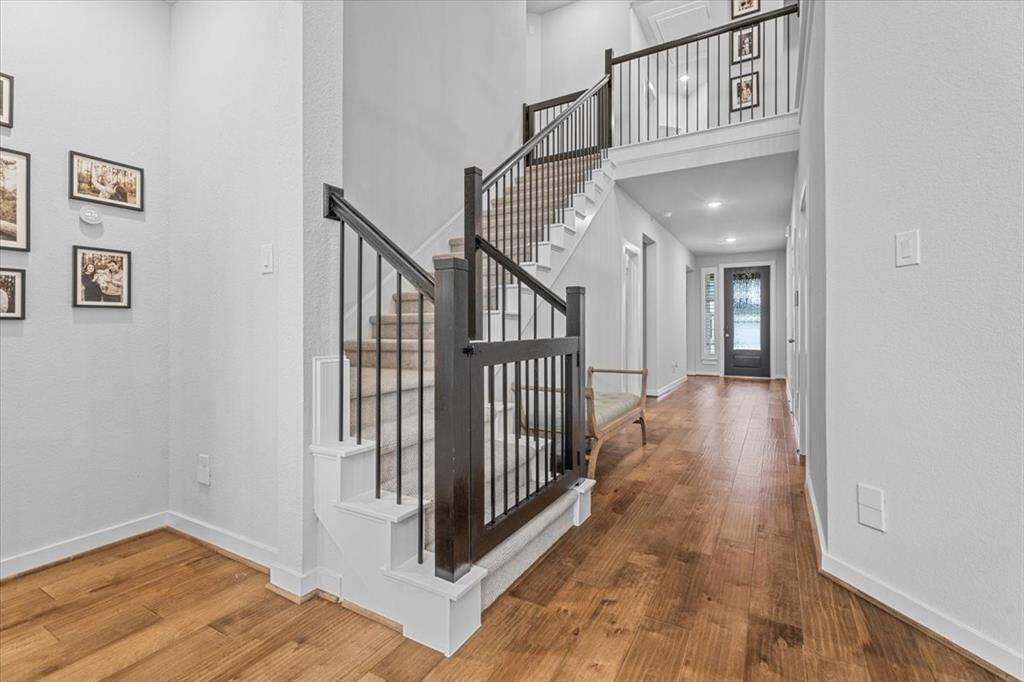 Beautiful stairway leading to the second floor, featuring a custom banister and locking gates.