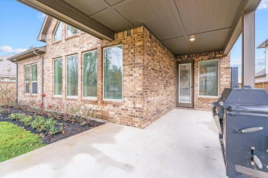 Charming patio with large windows with a covered area, perfect for outdoor entertaining.