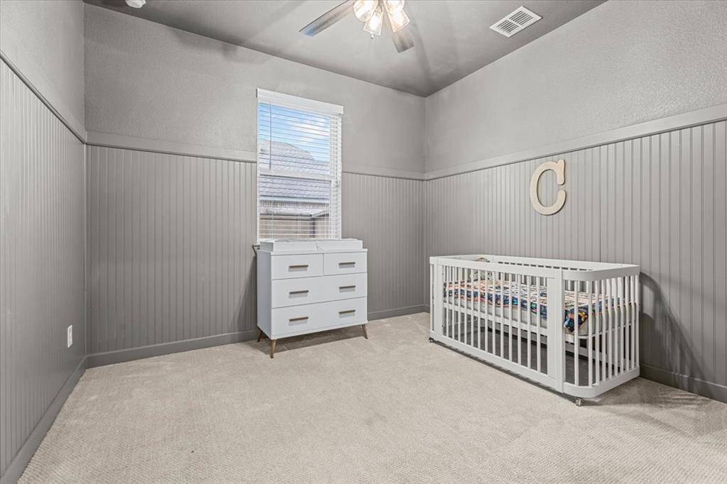 Bedroom downstairs with vaulted ceilings and access to a bathroom equipped with a walk-in shower.