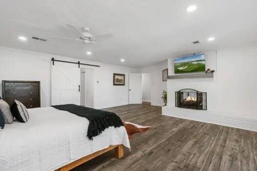 The primary suite has tons of space, a brick fireplace for those cool winter nights, and barn door that opens to the en-suite bath!