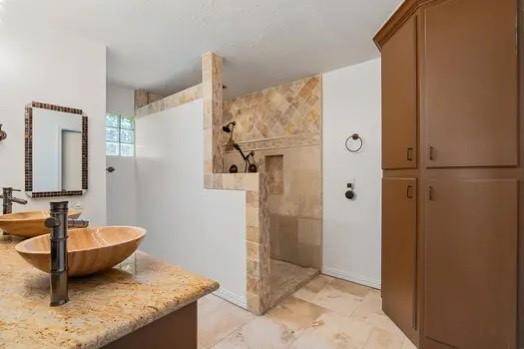 Double sinks, large walk-in shower, and lots of storage space.