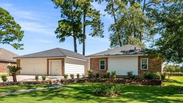 A spacious lot surround by mature trees and pretty landscaping offers great curb appeal!