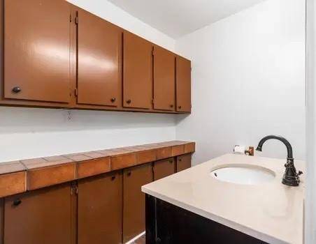A half bath has a wall of storage for anything and everything!