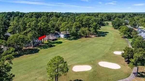 This home is nestled amongst the trees on the 5th hole of the Championship Golf Course in April Sound!